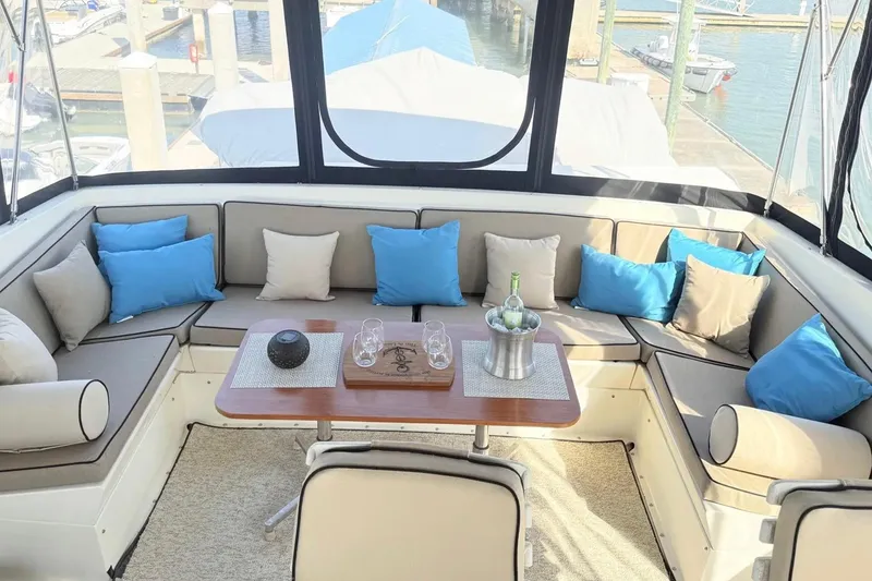 Slide: The Image of Luxurious seating area on 1987 Hatteras 54 Motor Yacht with blue and beige cushions. - 79