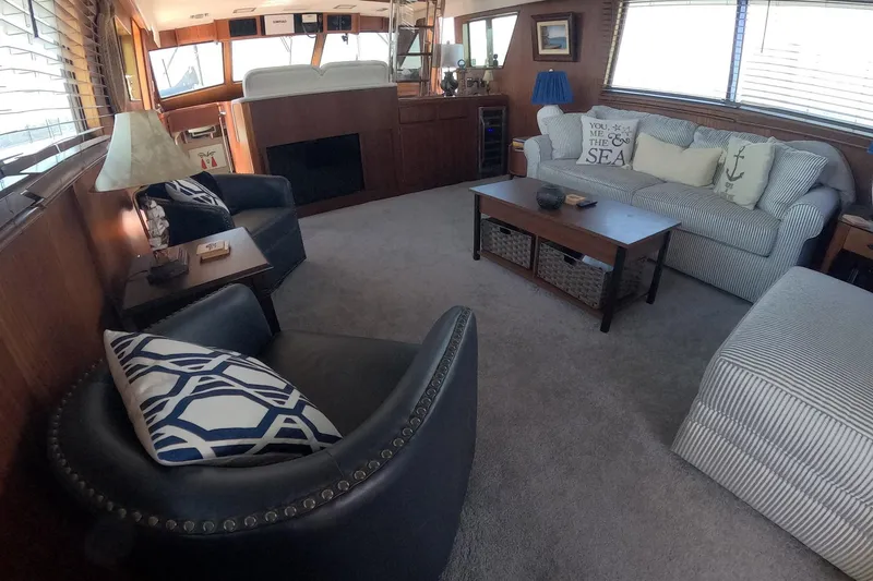 Slide: The Image of Luxurious interior of 1987 Hatteras 54 Motor Yacht with cozy seating and nautical decor. - 8