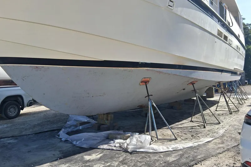 Slide: The Image of 1987 Hatteras 54 Motor Yacht on stands for maintenance, side view. - 82