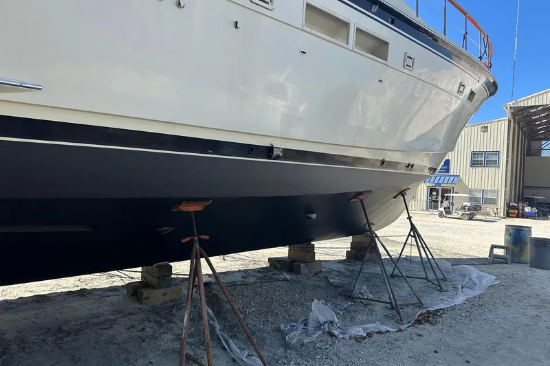 Slide: The Image of 1987 Hatteras 54 Motor Yacht on stands in a boatyard for maintenance. - 85