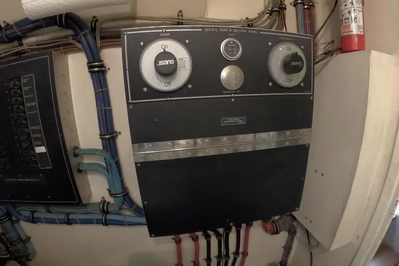 Slide: The Image of Electrical panel on a 1987 Hatteras 54 Motor Yacht, featuring battery controls and wiring. - 89