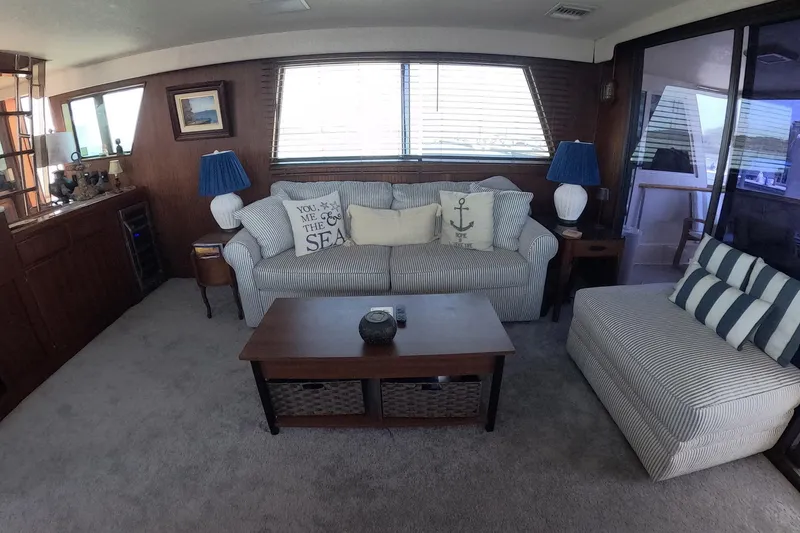 Slide: The Image of Interior of 1987 Hatteras 54 Motor Yacht with cozy seating and nautical decor. - 9
