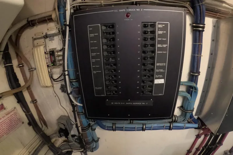 Slide: The Image of Electrical panel on a 1987 Hatteras 54 Motor Yacht with labeled switches and wiring. - 90