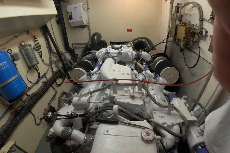 Slide: The Image of Engine room of a 1987 Hatteras 54 Motor Yacht, showcasing mechanical components. - 95