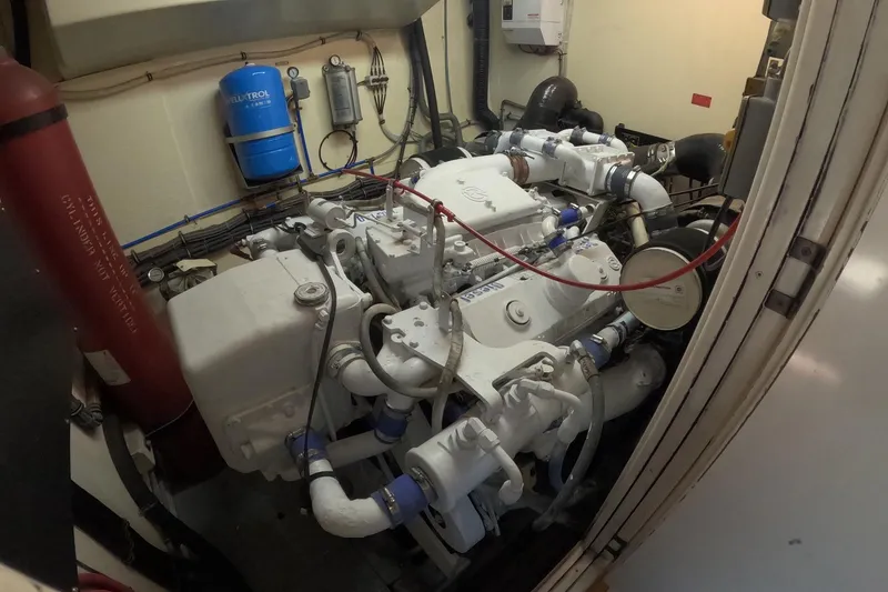 Slide: The Image of Engine room of a 1987 Hatteras 54 Motor Yacht with visible machinery and equipment. - 96