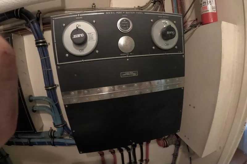 Slide: The Image of Electrical panel on a 1987 Hatteras 54 Motor Yacht with wiring and controls. - 98