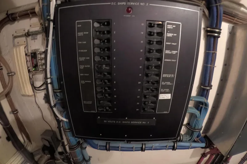 Slide: The Image of Electrical panel on a 1987 Hatteras 54 Motor Yacht, featuring labeled switches and wiring. - 99