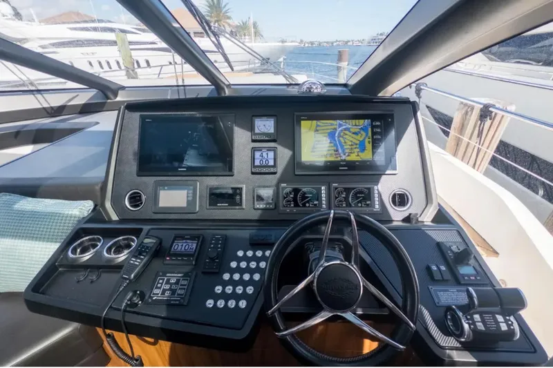 Slide: The Image of Helm of 2020 Sunseeker Predator 74 yacht with advanced navigation controls and displays. - 12
