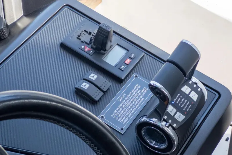 Slide: The Image of Control panel of 2020 Sunseeker Predator 74 yacht with throttle and switches. - 13