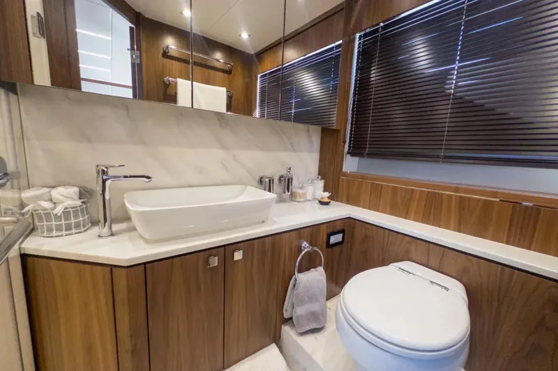 Slide: The Image of Luxurious bathroom in 2020 Sunseeker Predator 74 yacht with modern fixtures and wood accents. - 20