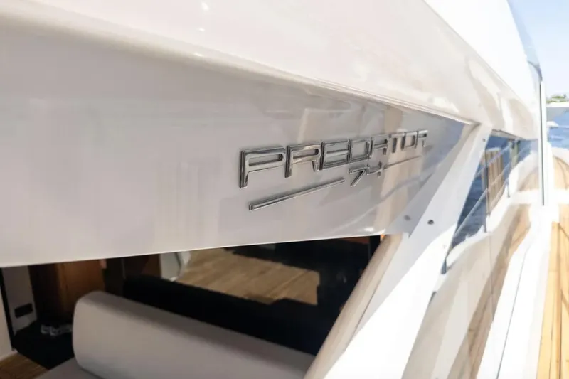 Slide: The Image of 2020 Sunseeker Predator 74 yacht, sleek design with metallic logo detail. - 7