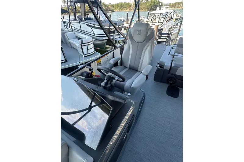 Slide: The Image of 2026 Godfrey Monaco 235 SFL boat interior with captain's chair and steering wheel. - 10