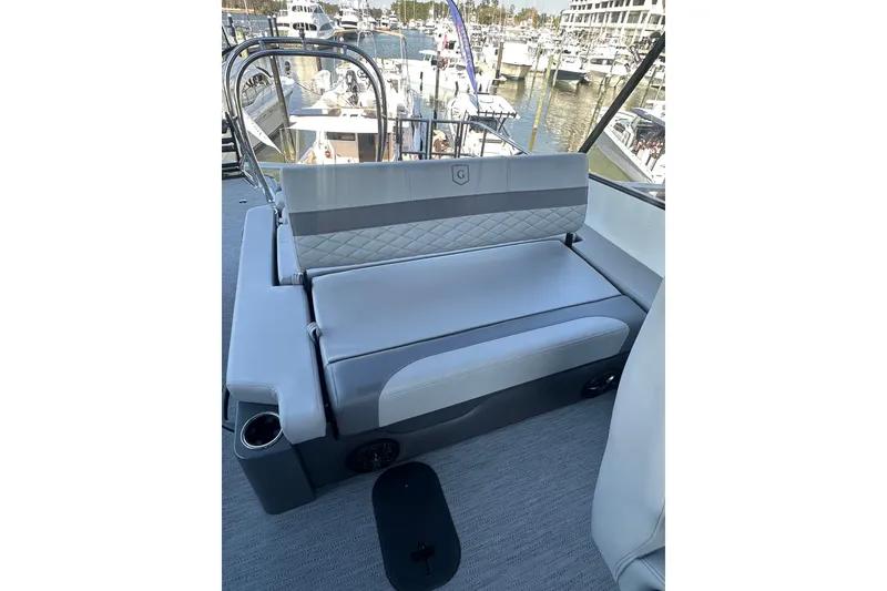 Slide: The Image of Luxurious seating on the 2026 Godfrey Monaco 235 SFL boat, docked at a marina. - 14