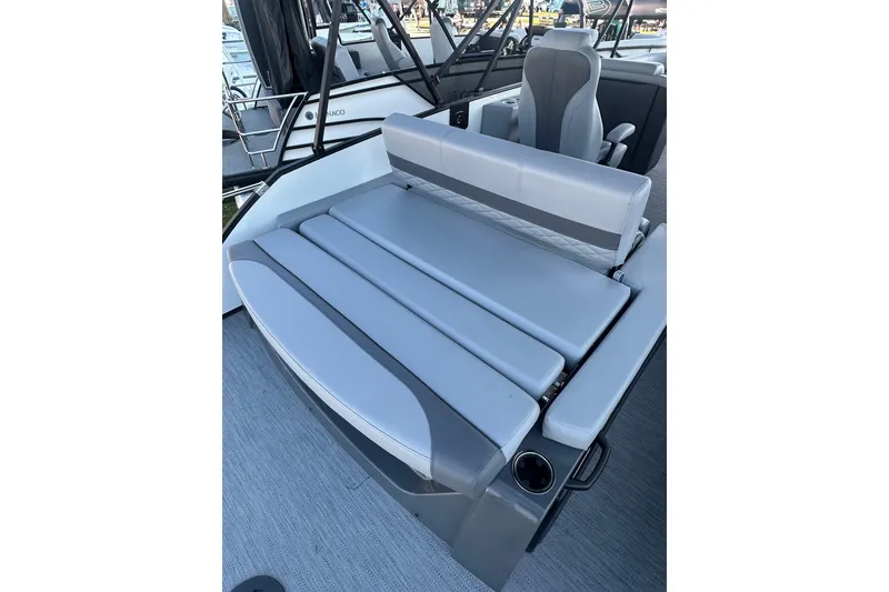 Slide: The Image of 2026 Godfrey Monaco 235 SFL boat interior with gray seating and cup holder. - 16