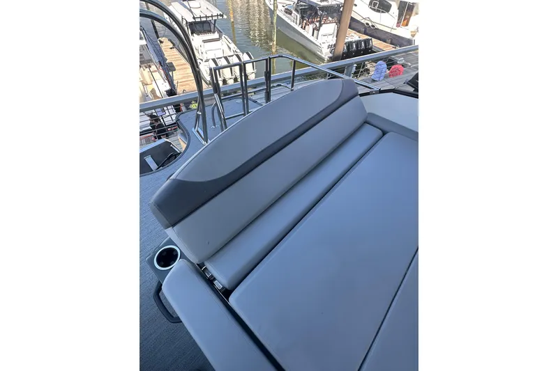 Slide: The Image of Luxury seating on 2026 Godfrey Monaco 235 SFL boat, docked at marina. - 18
