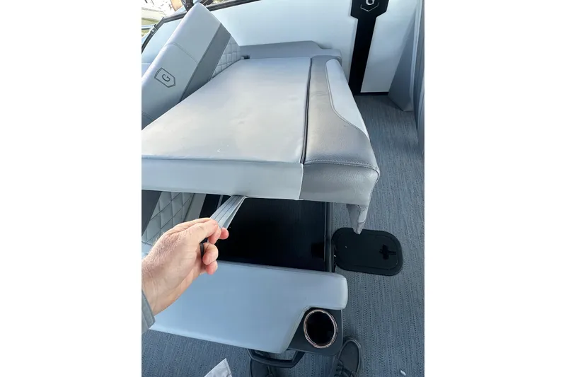 Slide: The Image of Hand adjusting seat on 2026 Godfrey Monaco 235 SFL boat, showcasing interior design. - 22