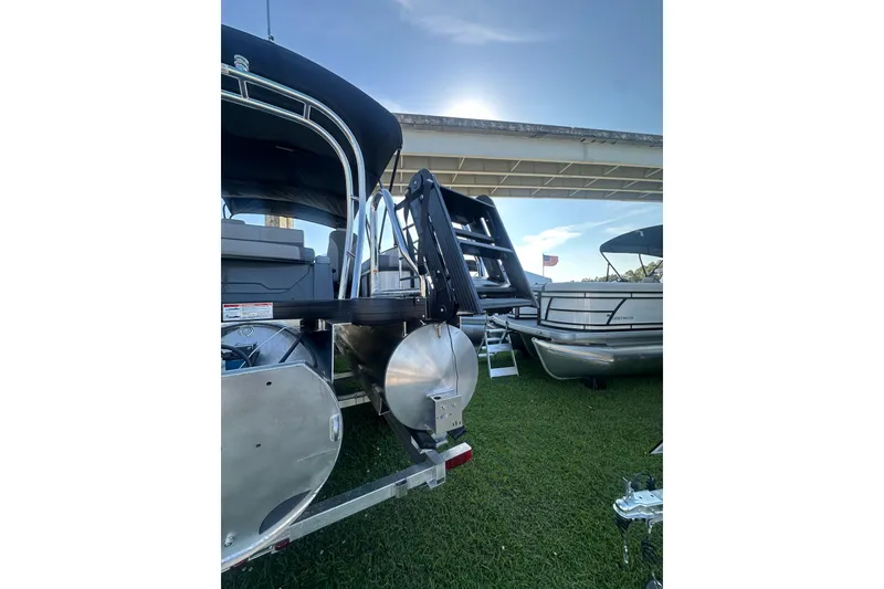 Slide: The Image of 2026 Godfrey Monaco 235 SFL pontoon boat displayed outdoors on grass. - 3