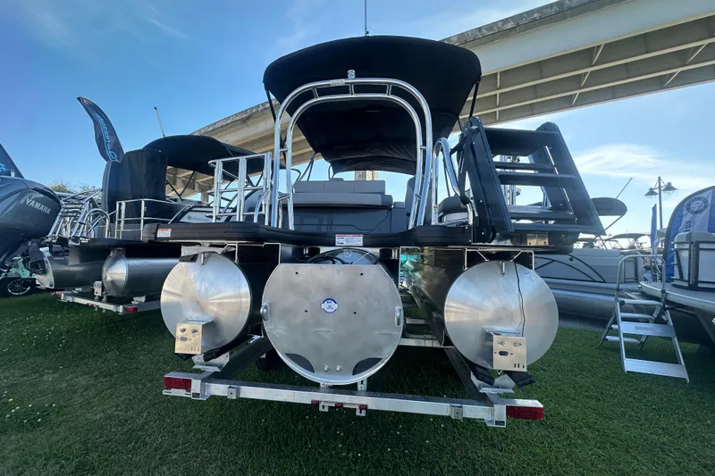 Slide: The Image of 2026 Godfrey Monaco 235 SFL pontoon boat displayed outdoors under a bridge. - 4