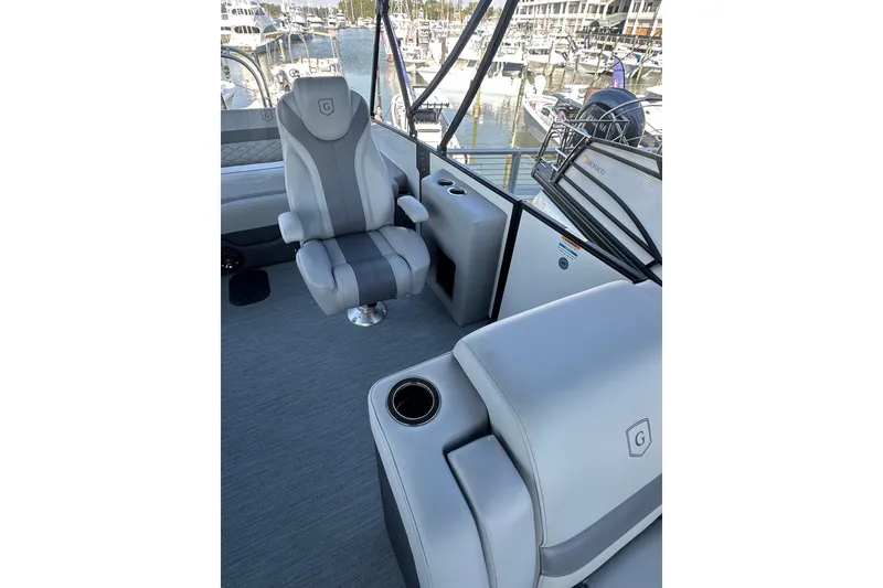 Slide: The Image of Luxurious interior of 2026 Godfrey Monaco 235 SFL boat with plush seating and marina view. - 9