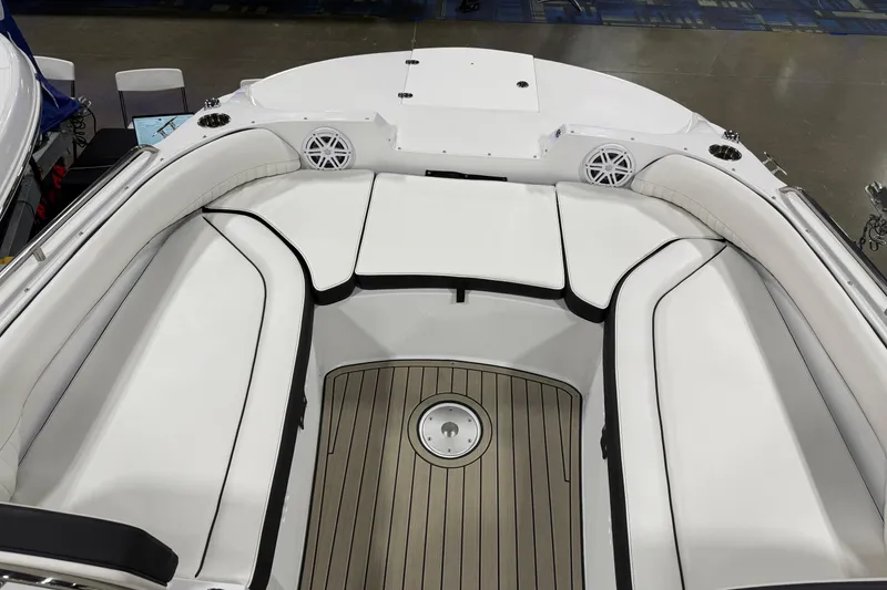 Slide: The Image of 2026 Stingray 212 SC boat interior with white seating and wood-style flooring. - 10