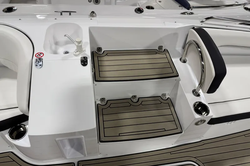 Slide: The Image of 2026 Stingray 212 SC boat interior with steps and seating area. - 11