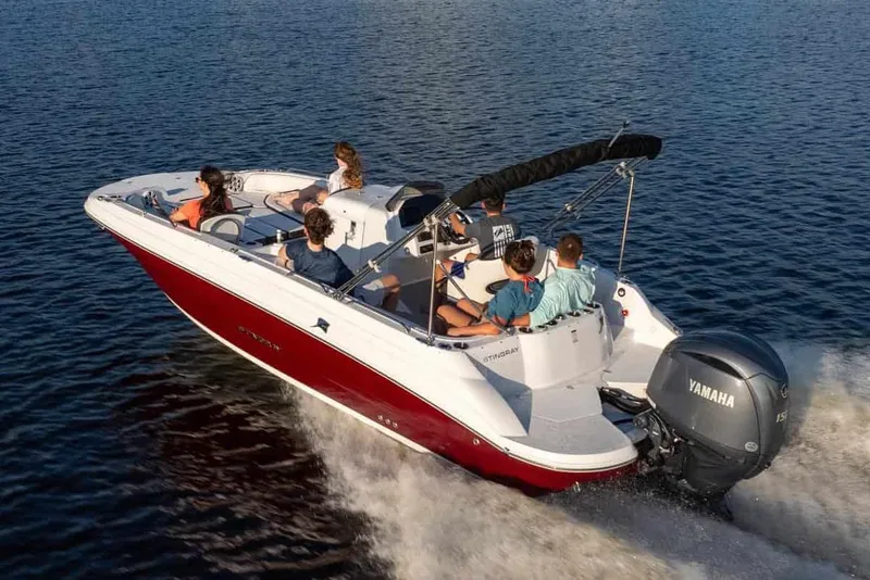 Slide: The Image of Manufacturer Provided Image: 2026 Stingray 212 SC boat cruising on water with passengers enjoying the ride. - 13