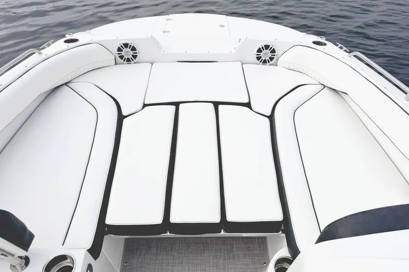 Slide: The Image of Manufacturer Provided Image: 2026 Stingray 212 SC boat interior with white cushioned seating and speakers. - 14