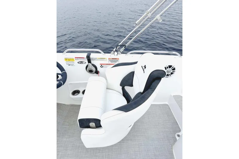 Slide: The Image of Manufacturer Provided Image: Captain's seat on 2026 Stingray 212 SC boat, overlooking calm water. - 16