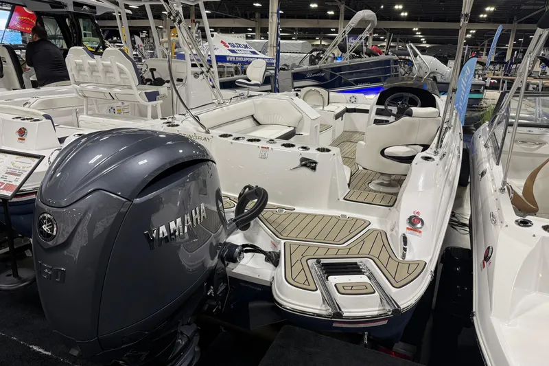 Slide: The Image of 2026 Stingray 212 SC boat with Yamaha engine displayed at a boat show. - 2