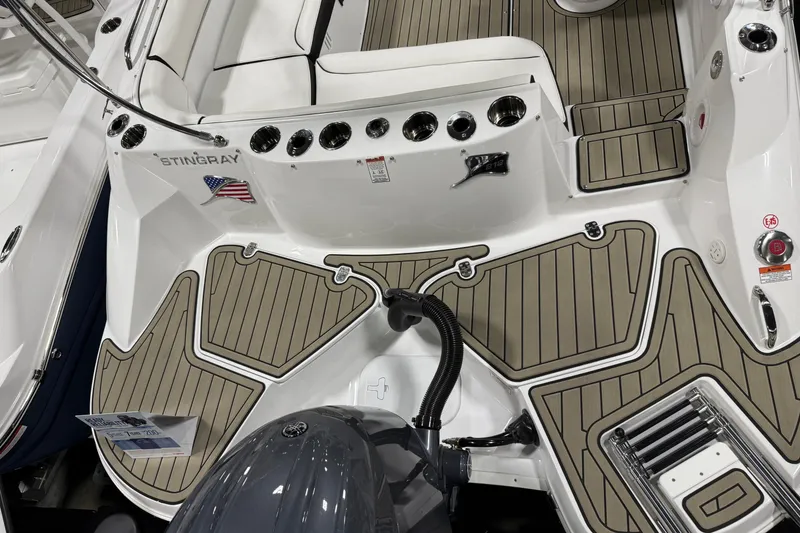 Slide: The Image of 2026 Stingray 212 SC boat deck with seating, cup holders, and American flag detail. - 3