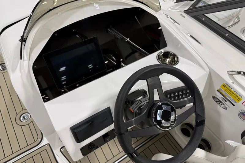 Slide: The Image of Interior view of 2026 Stingray 212 SC boat cockpit with steering wheel and dashboard. - 5