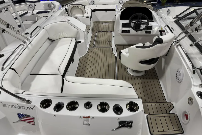 Slide: The Image of 2026 Stingray 212 SC boat interior with white seating and modern dashboard. - 6