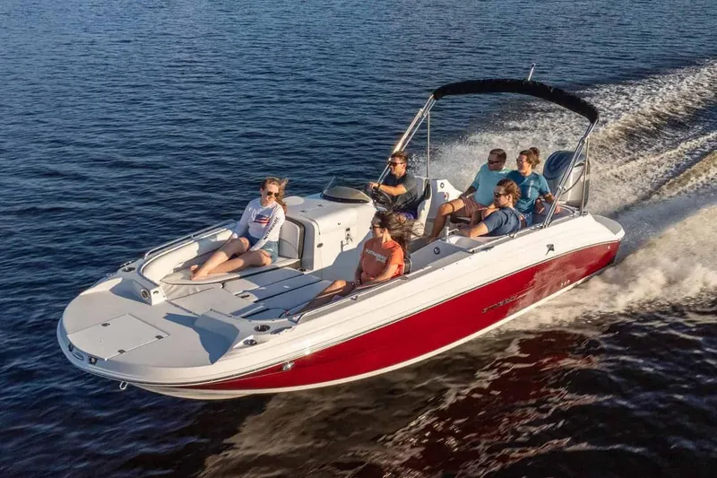 Slide: The Image of Manufacturer Provided Image: 2026 Stingray 212 SC boat cruising on water with passengers enjoying the ride. - 7