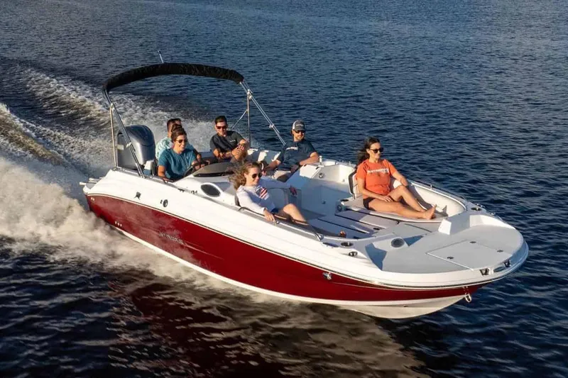 Slide: The Image of Manufacturer Provided Image: 2026 Stingray 212 SC boat cruising on water with passengers enjoying the ride. - 8