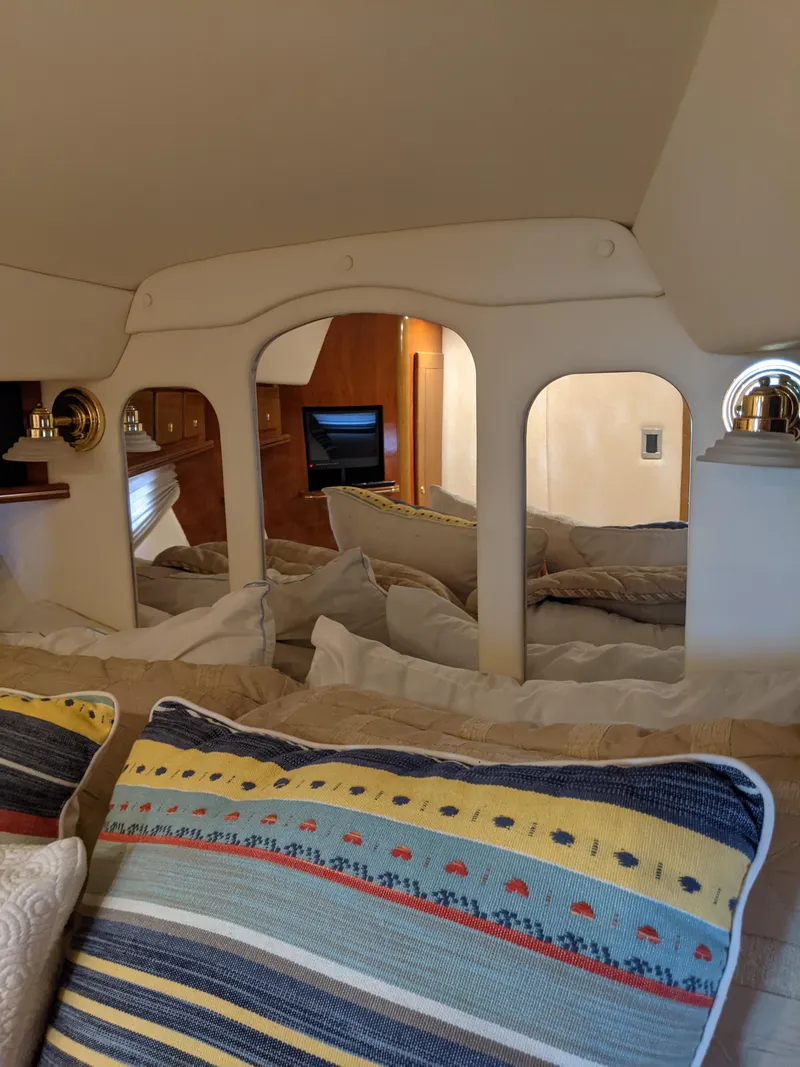 Slide: The Image of Interior of 2004 Rinker Fiesta Vee 410 yacht with cozy bedding and decorative pillows. - 16