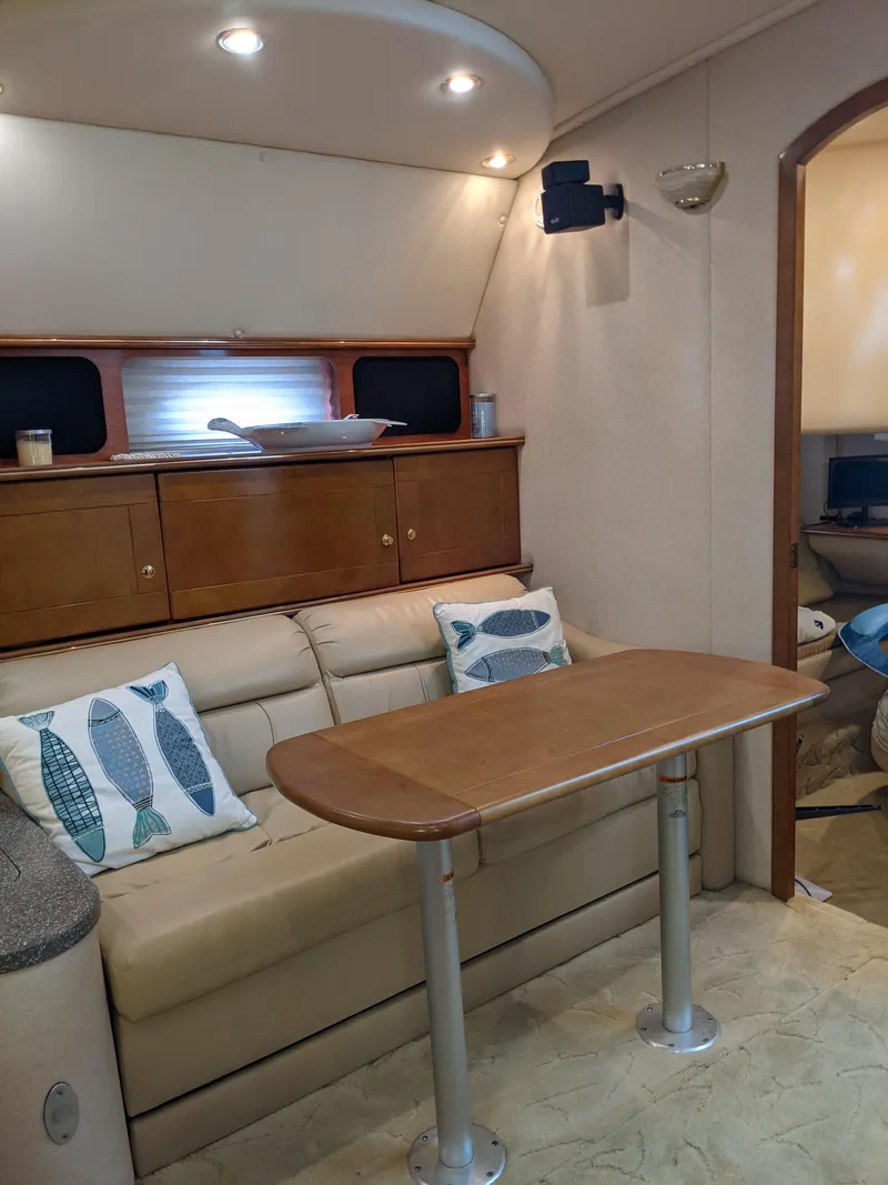 Slide: The Image of Interior of 2004 Rinker Fiesta Vee 410 yacht with sofa, table, and nautical decor. - 29