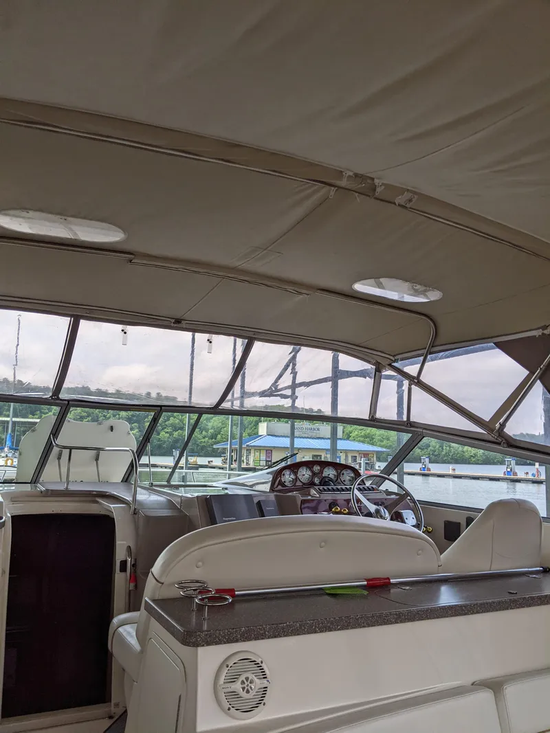 Slide: The Image of 2004 Rinker Fiesta Vee 410 boat interior with helm, docked at marina. - 34