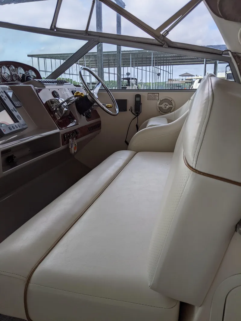 Slide: The Image of 2004 Rinker Fiesta Vee 410 boat interior with steering wheel and dashboard. - 37