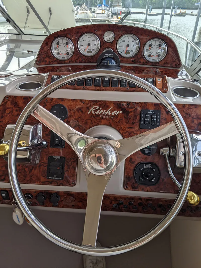 Slide: The Image of 2004 Rinker Fiesta Vee 410 helm with gauges and steering wheel. - 39