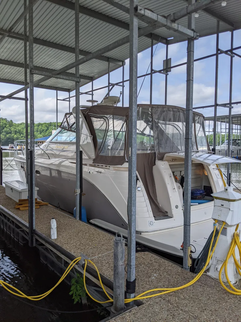 Slide: The Image of 2004 Rinker Fiesta Vee 410 docked under a covered marina. - 4