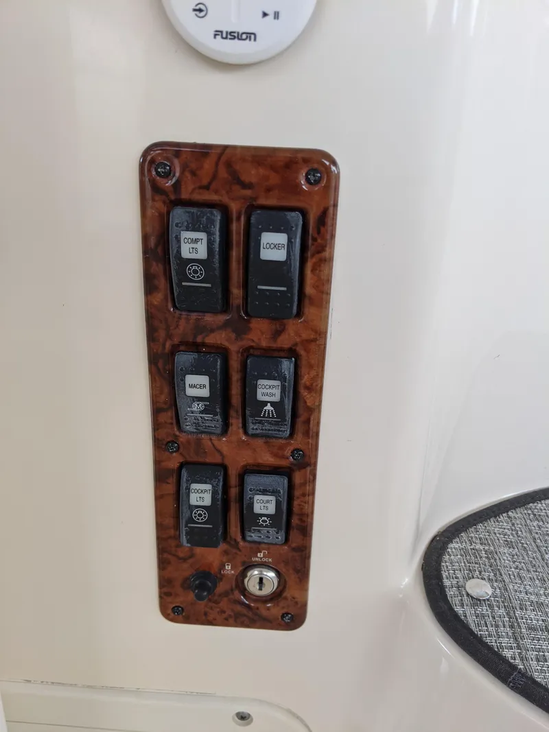 Slide: The Image of Control panel on 2004 Rinker Fiesta Vee 410 boat with multiple switches. - 42