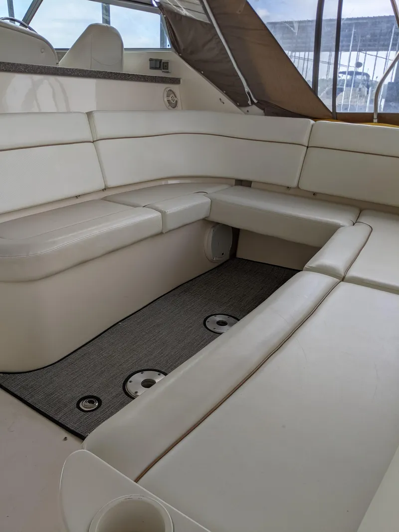 Slide: The Image of 2004 Rinker Fiesta Vee 410 boat interior with white cushioned seating. - 46