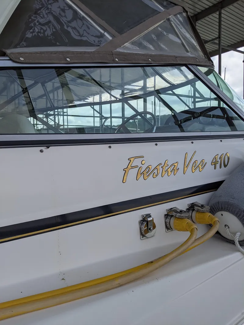 Slide: The Image of 2004 Rinker Fiesta Vee 410 boat docked with visible name and cables. - 6