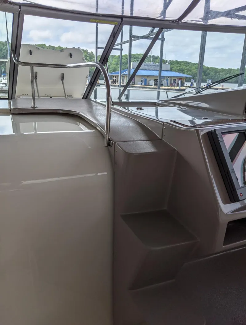 Slide: The Image of 2004 Rinker Fiesta Vee 410 boat interior with helm and navigation area. - 8