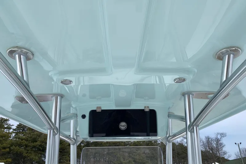 Slide: The Image of 2026 Pair Customs 24 Center Console DV Offshore boat's T-top structure, featuring sleek metal supports. - 8