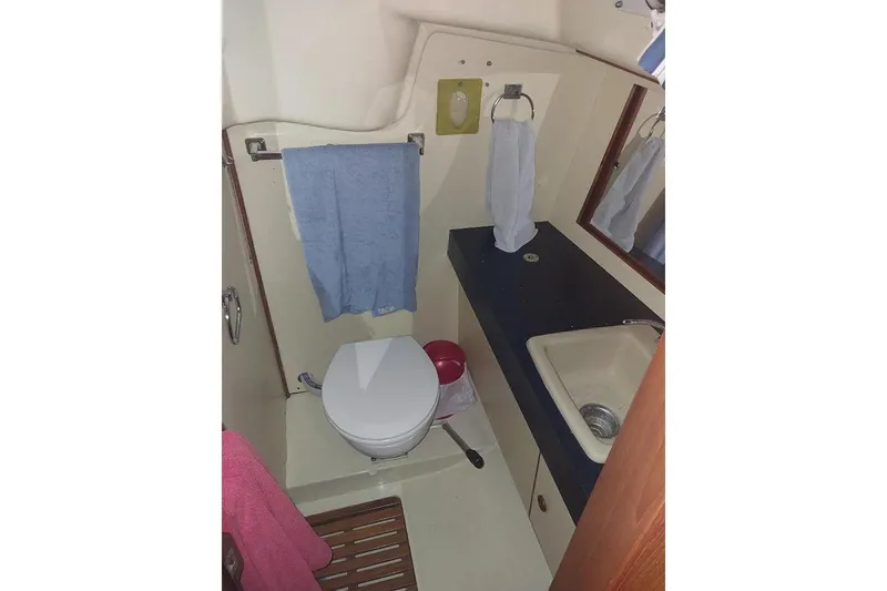 Slide: The Image of 1985 Pearson Yachts 36-2 bathroom with toilet, sink, and towels. - 11