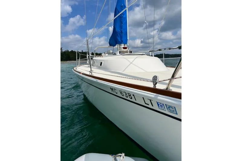Slide: The Image of 1985 Pearson Yachts 36-2 sailboat with blue sail on calm water. - 3