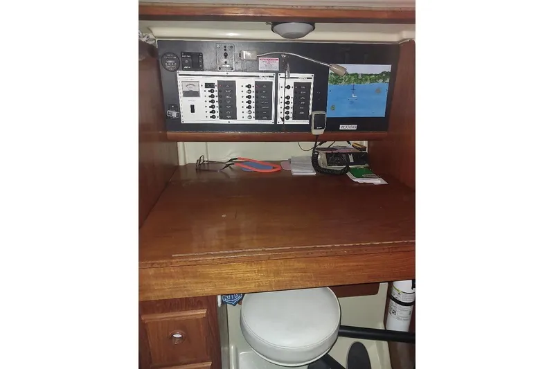 Slide: The Image of Navigation station inside a 1985 Pearson Yachts 36-2, featuring control panels and seating. - 9