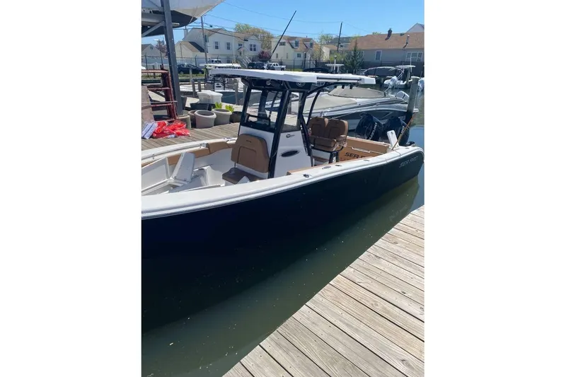 The Image of 2024 Sea Pro 259 DLX boat docked at a marina, showcasing sleek design. - 1