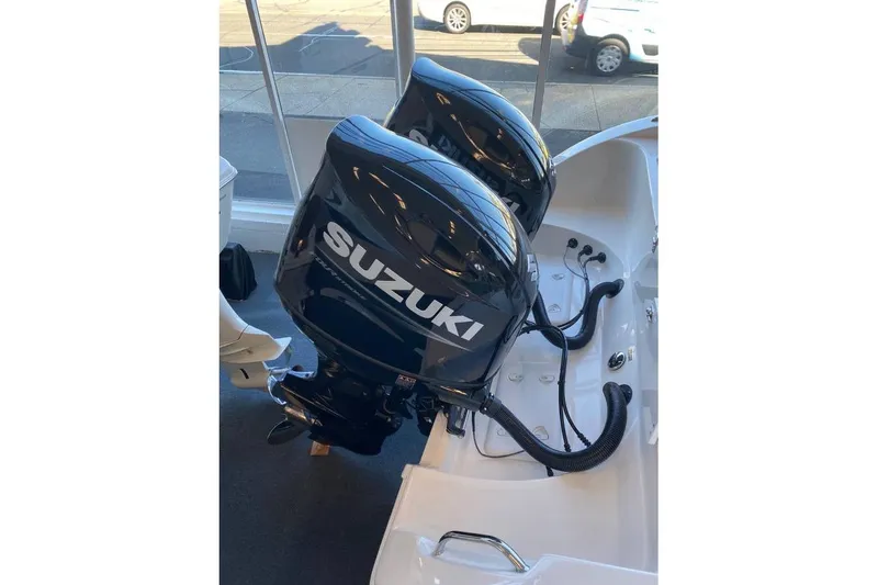 Slide: The Image of Twin Suzuki outboard motors on a 2024 Sea Pro 259 DLX boat. - 10